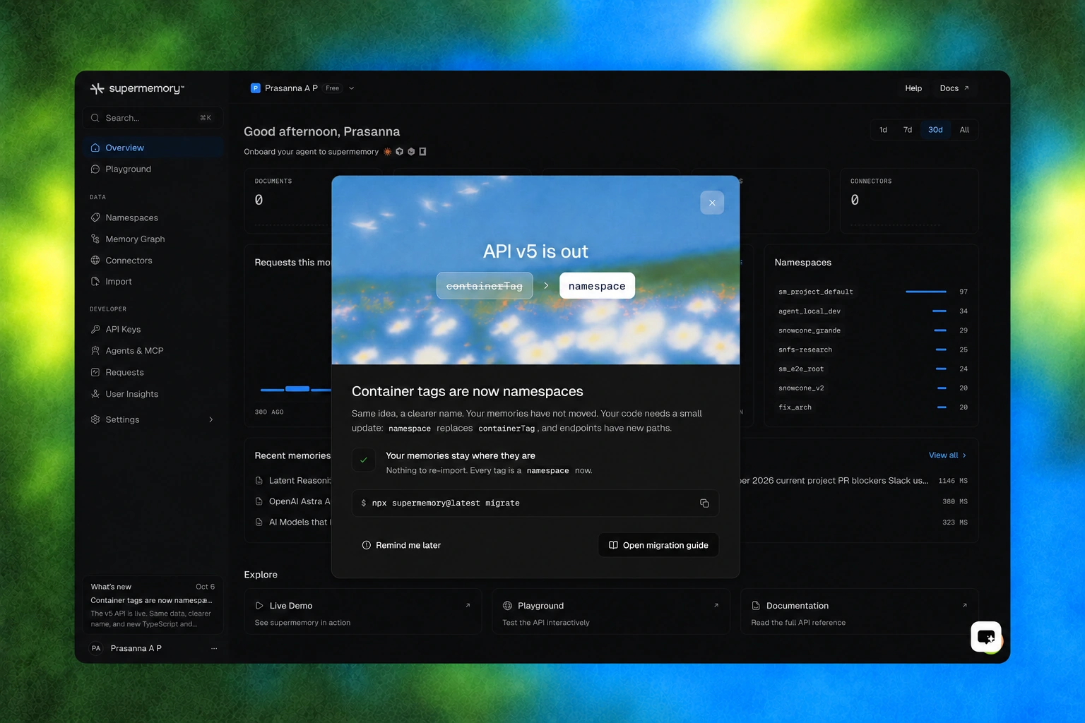 Supermemory Console in dark mode, with the API v5 namespace announcement open over the dashboard, framed by a blue and green mesh background.
